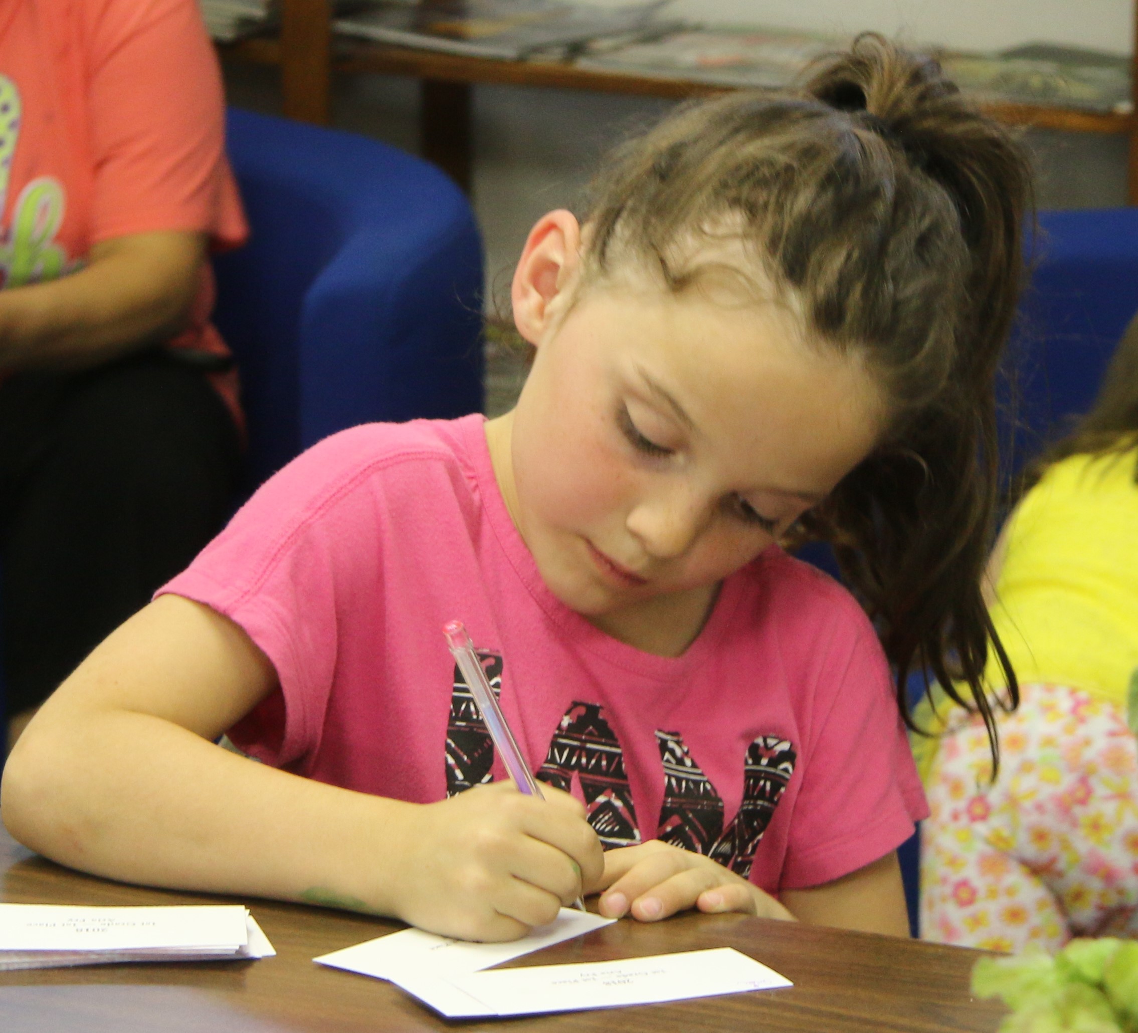 Aria signing her winning bookmark design