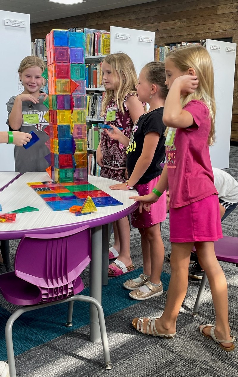 Girls building with tiles